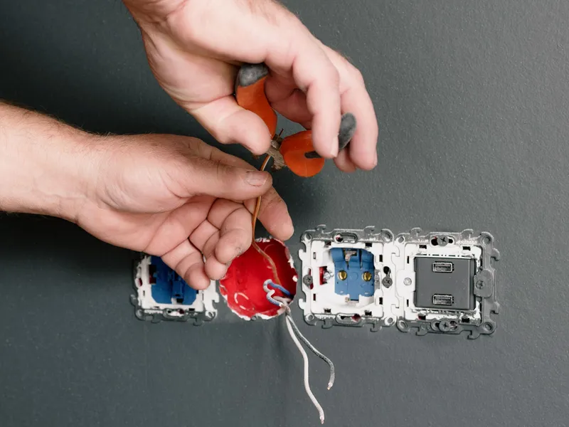Electrician wiring a new outlet and USB receptacle in Owasso, OK